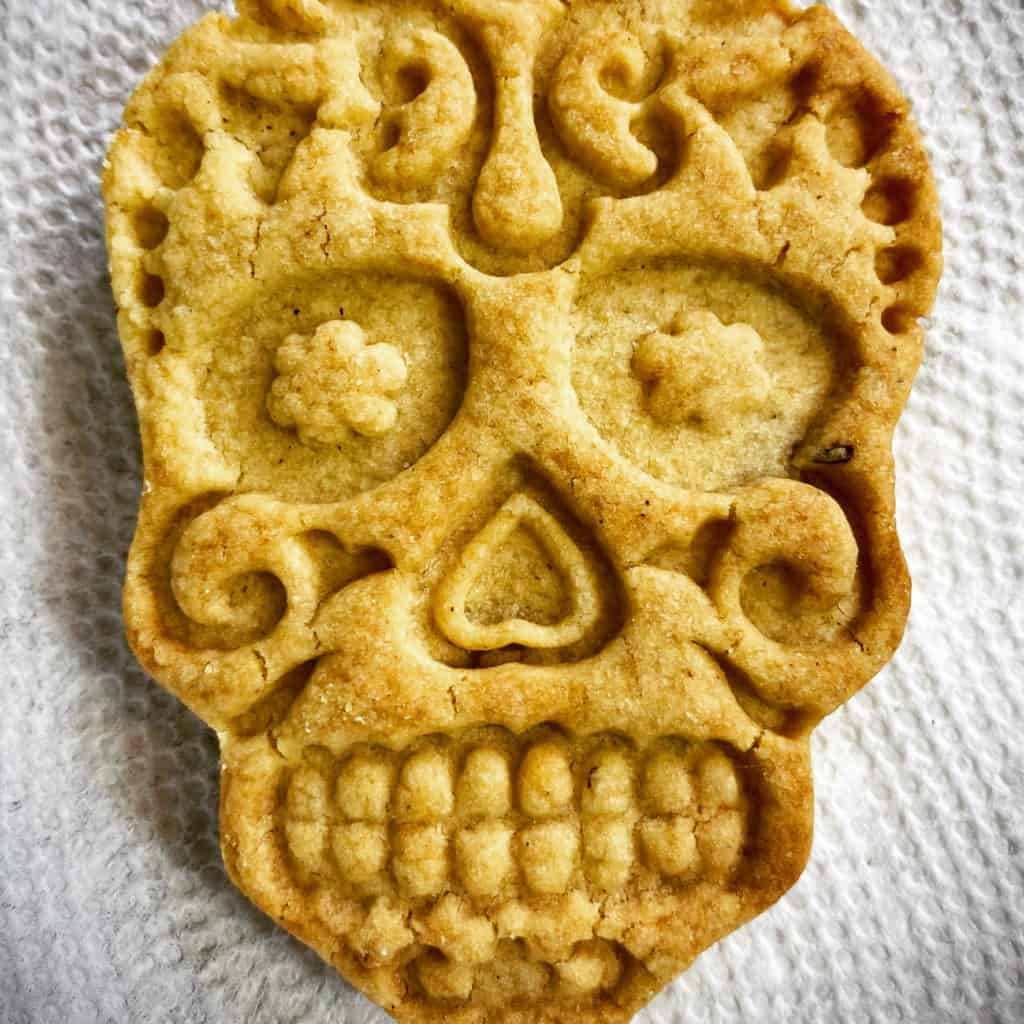A sugar skull sugar cookie with perfect edges and imprints