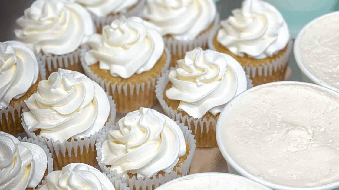 rows and rows of cupcakes with vanilla buttercream swirls