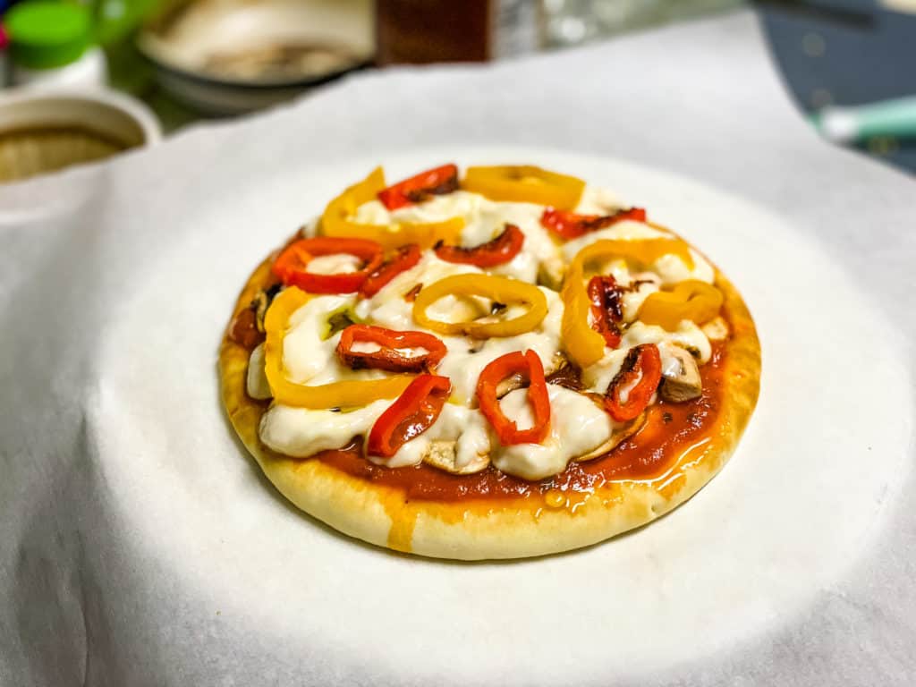 Mini cheesy pizza with sliced red baby bell peppers