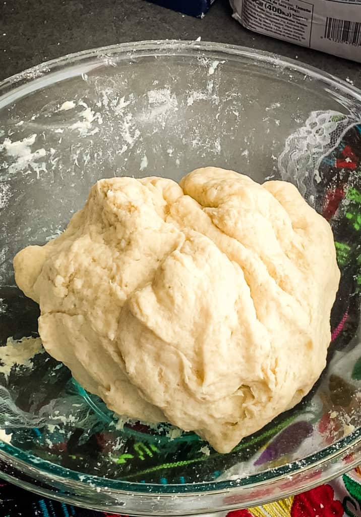A smooth dough ball in the glass mixing bowl