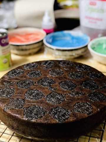 A baked chocolate cake with oreos visible after being baked into the bottom of the cake