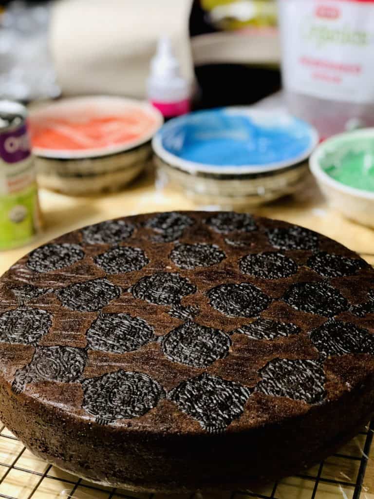 A baked chocolate cake with oreos visible after being baked into the bottom of the cake