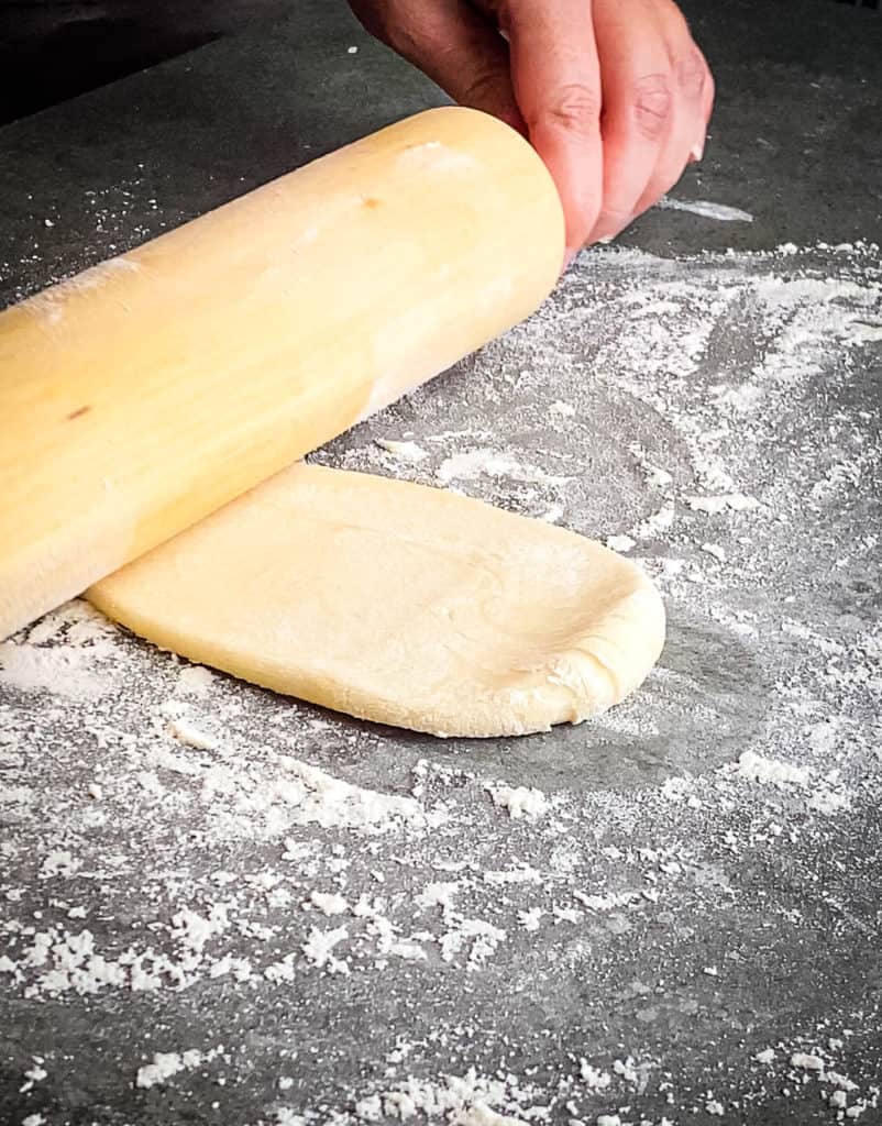 The rolling pin at the bottom of the testal after rolling down from the middle