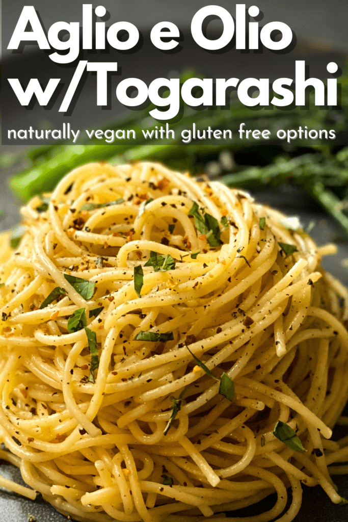 a big mound of delicious spaghetti on a grey plate and broccolini in the background with text on top that reads Oglio e Olio w/Togarashi natrually vegan with gluten free options