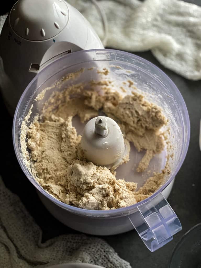 water has been added to the flour mixture and its now a smooth but sticky dough - like wet clay