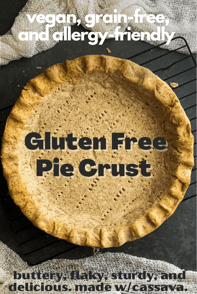 Looking down on a golden brown pie crust with crimped edges and fork marks throughout. Text overlay says gluten free pie crust vegan grain free and allergy friendly buttery flaky and delicious made with cassava