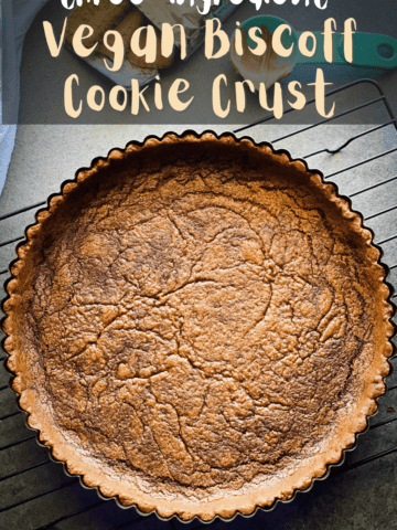 Finished cookie crust from above. It's a lovely deep brown color which is wrinkled and textured like a gingersnap cookie. Text overlay reads three ingredient vegan biscoff cookie crust, cookies, cookie butter, and water