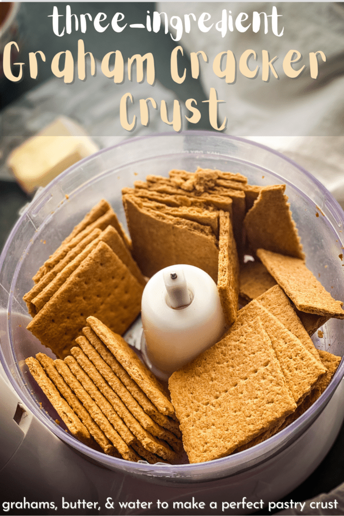 a food processor bowl filled with graham crackers and a half a stick of butter in the background. Text overlay reads "three ingredient graham cracker pie crust, grahams, butter, & water to make a perfect pastry crust